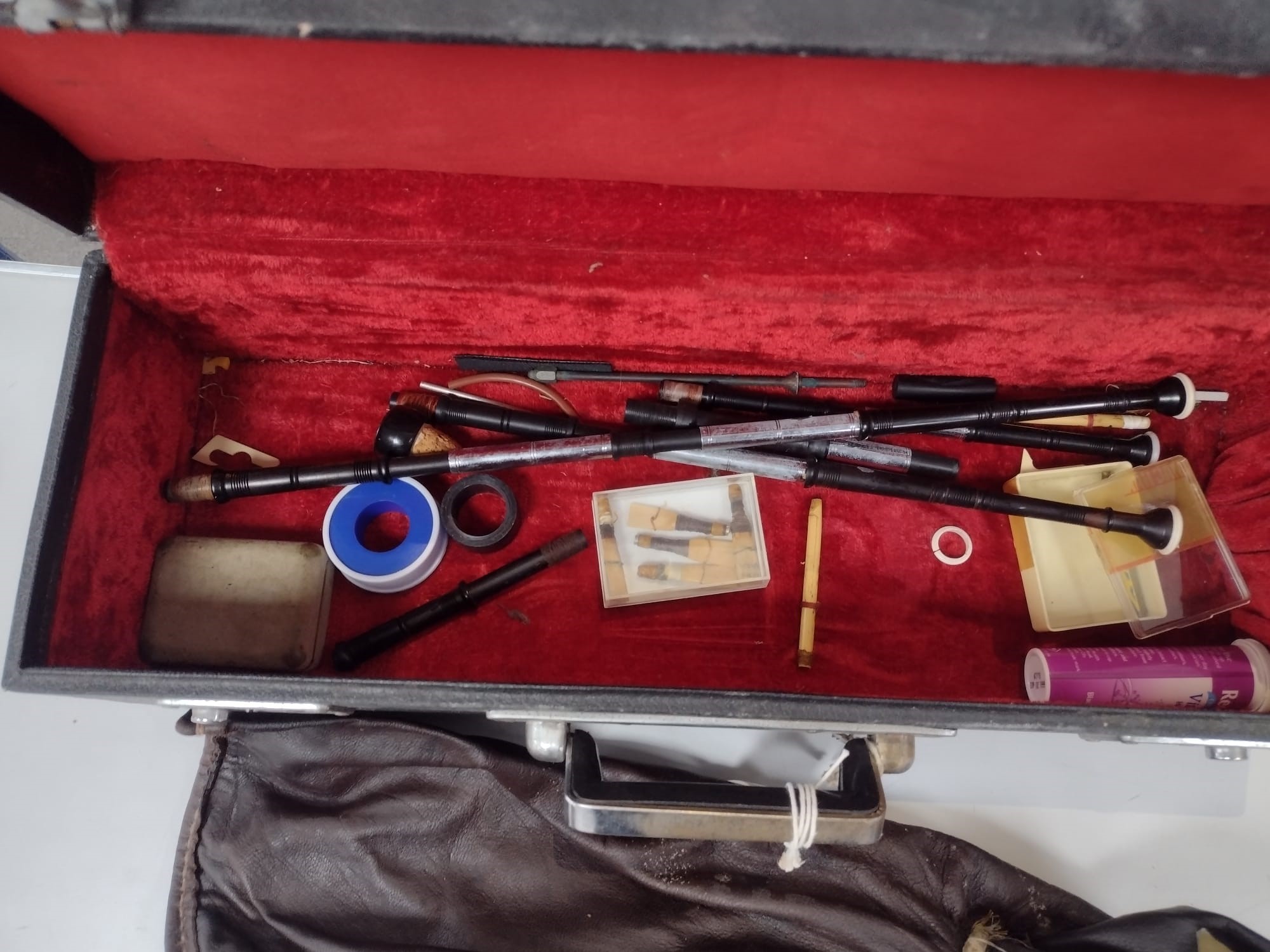 One violin, three violin cases and a cased set of bagpipes